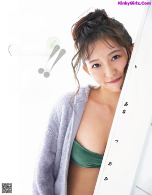 A woman in a green bikini posing for a picture.