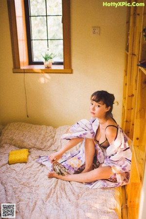 A woman sitting on the floor in a living room.