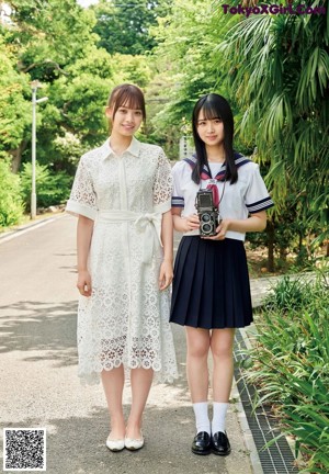 A couple of young women standing next to each other.