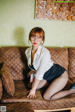 A woman in a black lingerie sitting on the stairs.