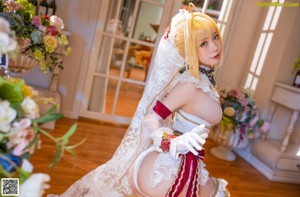 A woman in a wedding dress is posing for a picture.