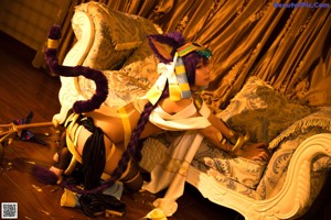 A woman in a cat costume sitting on the floor.