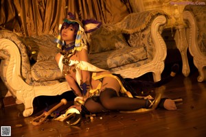 A woman laying on top of a bed in a costume.