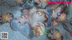 A woman laying on the ground surrounded by flowers.