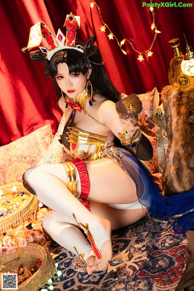 A woman in a costume sitting on a bed.