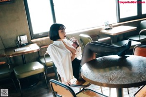 A woman sitting at a table in a restaurant.