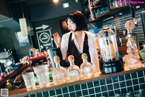 A woman sitting at a table in a restaurant.