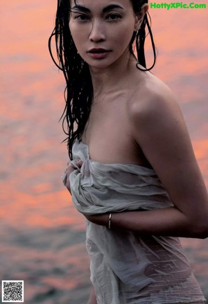 A woman in a black bikini posing for a picture.