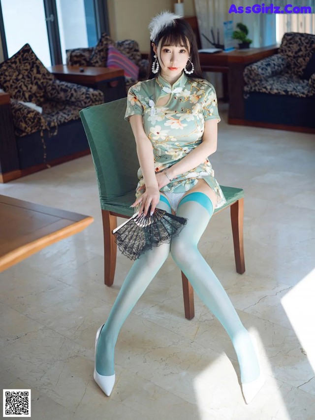 A woman sitting on a chair in a living room.