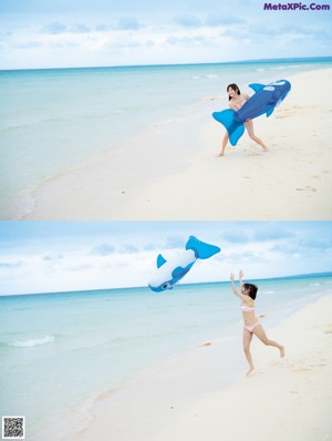 A woman in a bikini holding an inflatable shark in the ocean.