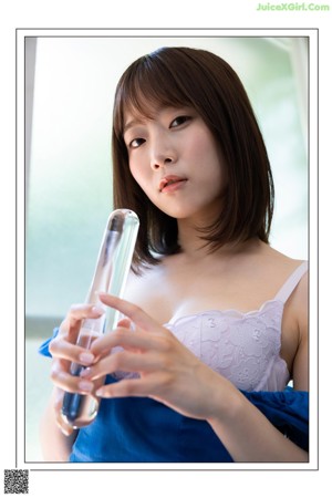 A woman in a blue top and a white skirt.